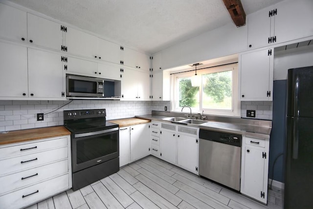 7579 Rangeline Rd, Mount Vernon, OH 43050 - kitchen featuring black appliances, backsplash, white cabinetry, beamed ceiling, and wooden counters