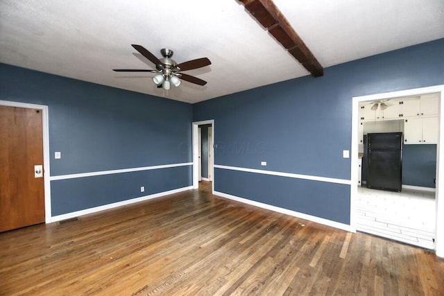 7579 Rangeline Rd, Mount Vernon, OH 43050 - unfurnished living room with a ceiling fan, wood finished floors, and beamed ceiling