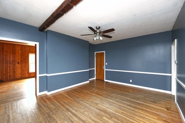7579 Rangeline Rd, Mount Vernon, OH 43050 - spare room featuring ceiling fan, wood finished floors, and beamed ceiling