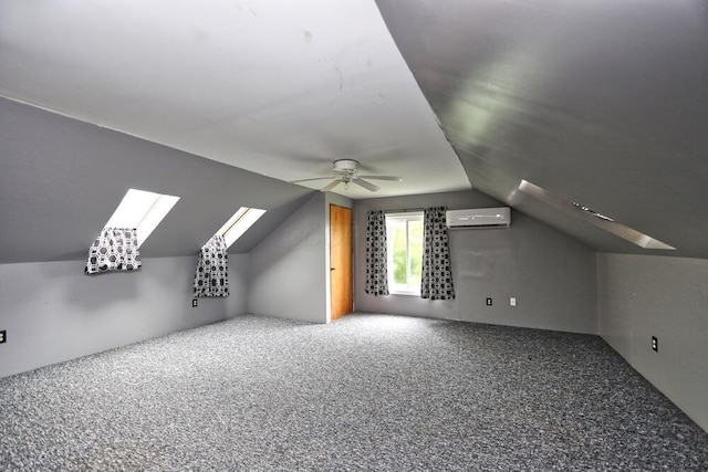 7579 Rangeline Rd, Mount Vernon, OH 43050 - additional living space with an AC wall unit, lofted ceiling, carpet floors, a skylight, and a ceiling fan