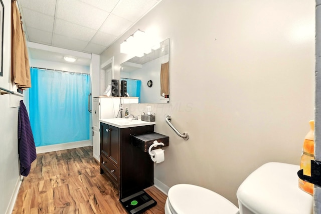 78 E St, Bellville, OH 44813 - bathroom featuring vanity, wood finished floors, a shower with shower curtain, backsplash, and a paneled ceiling