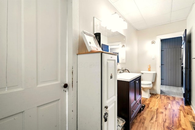 78 E St, Bellville, OH 44813 - bathroom featuring vanity, wood finished floors, and a drop ceiling