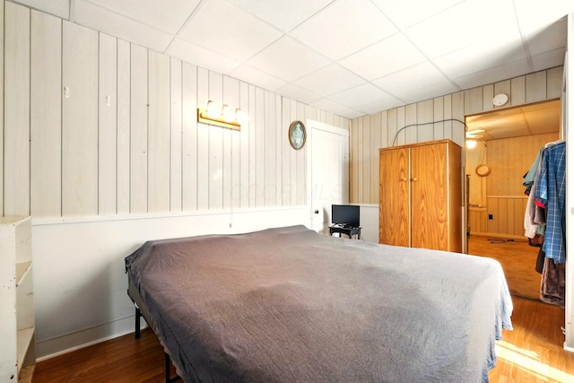 78 E St, Bellville, OH 44813 - bedroom with wood finished floors, wood walls, and a drop ceiling