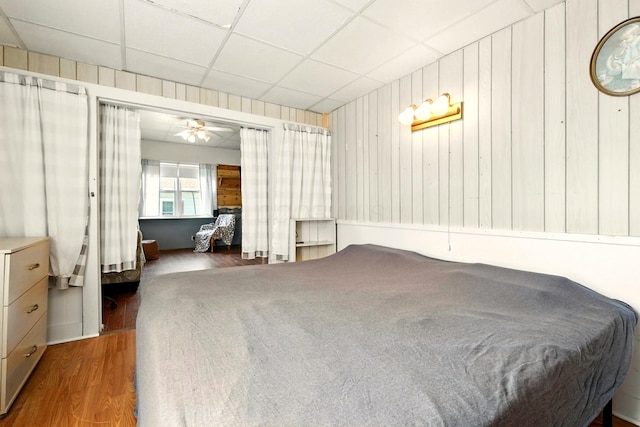 78 E St, Bellville, OH 44813 - bedroom with wood finished floors, a paneled ceiling, and wood walls