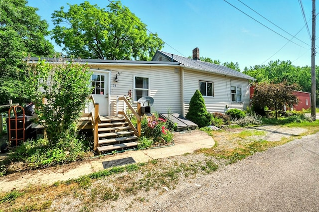 78 E St, Bellville, OH 44813 - view of front facade featuring a chimney and a metal roof
