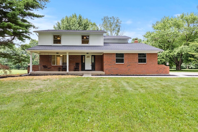 4250 Rutherford Rd, Powell, OH 43065 - view of front facade with a porch, a chimney, a front lawn, brick siding, and roof with shingles