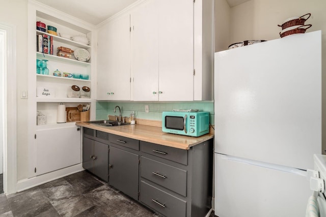 3445 Woodlawn Ave, Grove City, OH 43123 - kitchen featuring freestanding refrigerator, stainless steel microwave, gray cabinets, light countertops, and backsplash