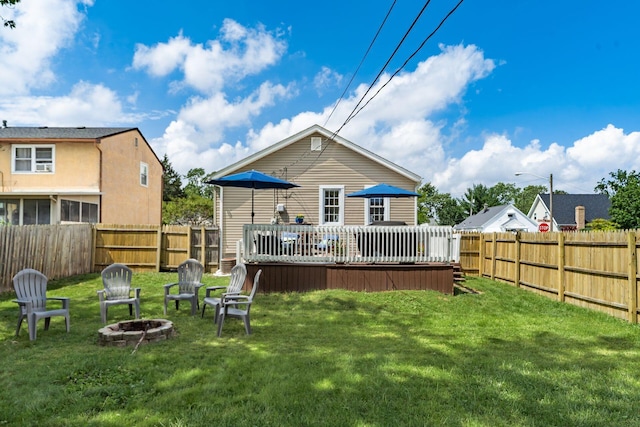 3445 Woodlawn Ave, Grove City, OH 43123 - back of property with an outdoor fire pit, a wooden deck, and a fenced backyard
