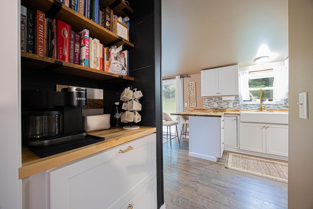 13399 Staddens Bridge Rd SE, Heath, OH 43056 - kitchen with wood counters, open shelves, light wood-style flooring, white cabinets, and tasteful backsplash