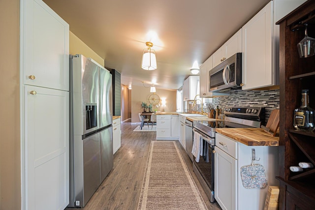 13399 Staddens Bridge Rd SE, Heath, OH 43056 - kitchen featuring stainless steel appliances, wood counters, a peninsula, backsplash, and white cabinetry