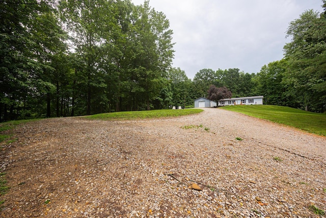 13399 Staddens Bridge Rd SE, Heath, OH 43056 - manufactured / mobile home with a detached garage, a wooded view, and a front lawn