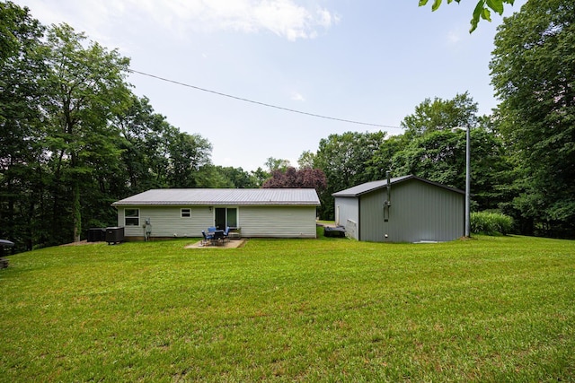 13399 Staddens Bridge Rd SE, Heath, OH 43056 - rear view of house with a lawn, a metal roof, and a patio area