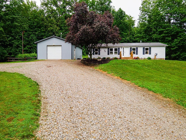 13399 Staddens Bridge Rd SE, Heath, OH 43056 - view of front facade featuring gravel driveway, an outbuilding, a front lawn, and a detached garage