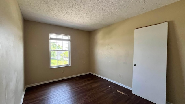 7831 Fairfax Loop Dr, Blacklick, OH 43004 - empty room featuring dark wood-type flooring and a textured ceiling