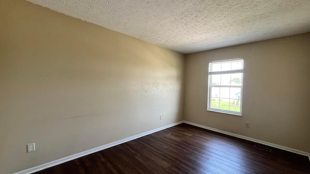 7831 Fairfax Loop Dr, Blacklick, OH 43004 - empty room featuring dark wood-style floors and a textured ceiling