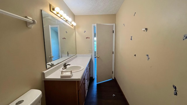 7831 Fairfax Loop Dr, Blacklick, OH 43004 - bathroom featuring a textured ceiling, vanity, and wood finished floors