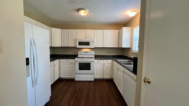 7831 Fairfax Loop Dr, Blacklick, OH 43004 - kitchen with white appliances, dark wood-type flooring, a textured ceiling, dark countertops, and white cabinets