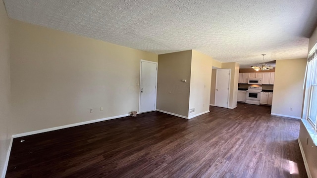 7831 Fairfax Loop Dr, Blacklick, OH 43004 - unfurnished living room featuring a chandelier, dark wood-type flooring, and a textured ceiling