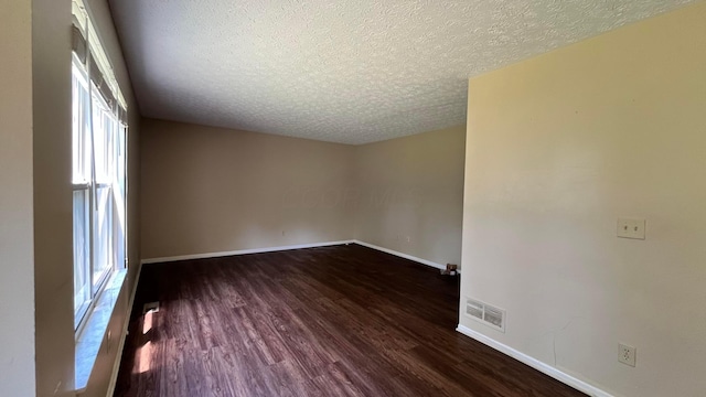 7831 Fairfax Loop Dr, Blacklick, OH 43004 - spare room with a textured ceiling and dark wood-style floors