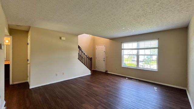 7831 Fairfax Loop Dr, Blacklick, OH 43004 - unfurnished living room with dark wood finished floors, stairway, and a textured ceiling
