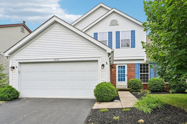 1016 Pebble Brook Dr, Columbus, OH 43240 - traditional-style house with a garage, asphalt driveway, and brick siding