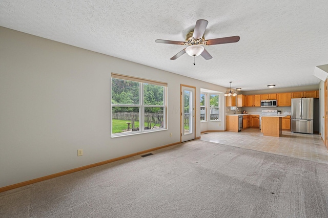 1016 Pebble Brook Dr, Columbus, OH 43240 - unfurnished living room with light carpet, a chandelier, a textured ceiling, and a ceiling fan