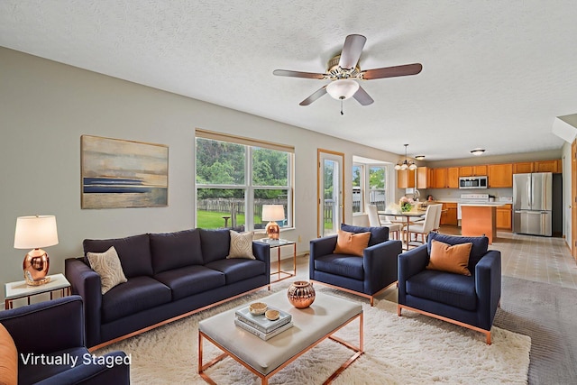 1016 Pebble Brook Dr, Columbus, OH 43240 - living room with a ceiling fan, light carpet, a textured ceiling, and a chandelier