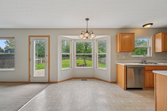1016 Pebble Brook Dr, Columbus, OH 43240 - kitchen featuring dishwasher, light countertops, brown cabinetry, a chandelier, and decorative light fixtures