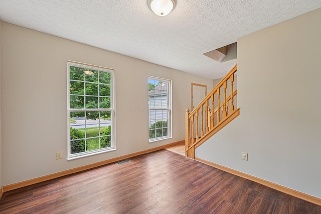 1016 Pebble Brook Dr, Columbus, OH 43240 - entrance foyer featuring wood finished floors, plenty of natural light, stairs, and a textured ceiling