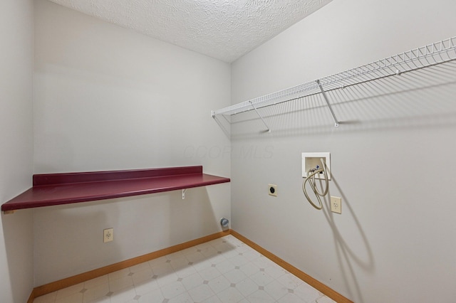 1016 Pebble Brook Dr, Columbus, OH 43240 - laundry room featuring electric dryer hookup, washer hookup, light flooring, and a textured ceiling