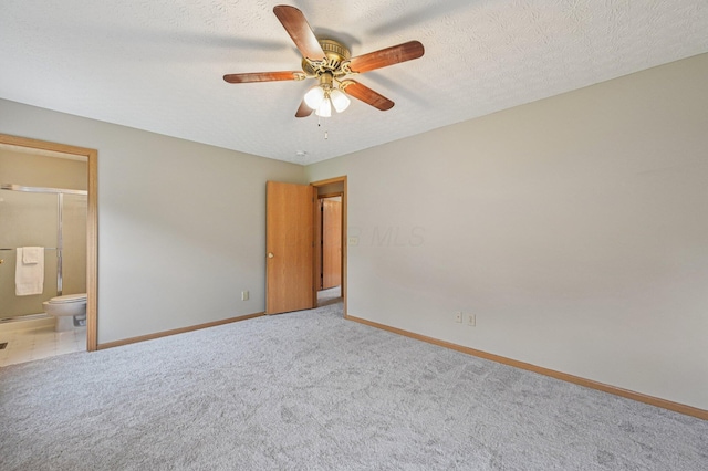 1016 Pebble Brook Dr, Columbus, OH 43240 - unfurnished bedroom featuring carpet flooring, connected bathroom, ceiling fan, and a textured ceiling
