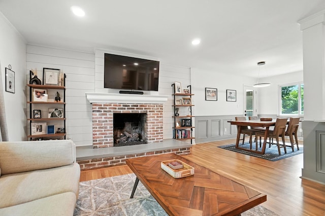 2820 Halstead Rd, Columbus, OH 43221 - living room featuring light wood-type flooring, a fireplace, recessed lighting, and a decorative wall