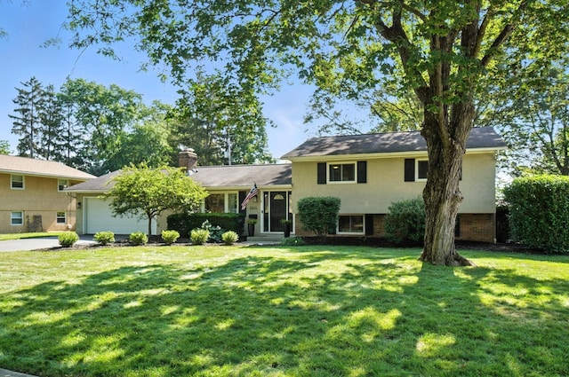 2820 Halstead Rd, Columbus, OH 43221 - split level home with an attached garage, a front yard, a chimney, and driveway