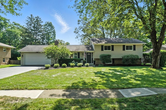 2820 Halstead Rd, Columbus, OH 43221 - tri-level home featuring a garage, driveway, stucco siding, and brick siding