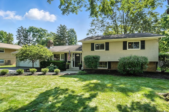 2820 Halstead Rd, Columbus, OH 43221 - tri-level home featuring a front lawn, concrete driveway, a chimney, an attached garage, and stucco siding
