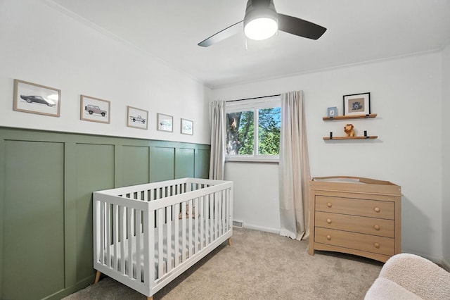 2820 Halstead Rd, Columbus, OH 43221 - carpeted bedroom with a nursery area, wainscoting, and a ceiling fan