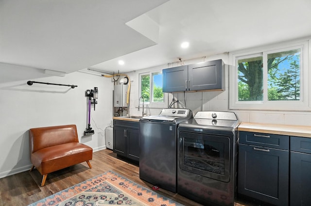2820 Halstead Rd, Columbus, OH 43221 - laundry room with cabinet space, washer and dryer, tankless water heater, wood finished floors, and recessed lighting