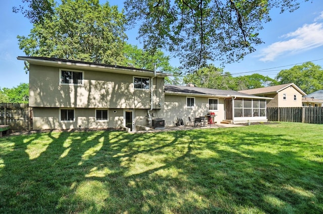 2820 Halstead Rd, Columbus, OH 43221 - back of property featuring a sunroom, a fenced backyard, a patio, and a chimney