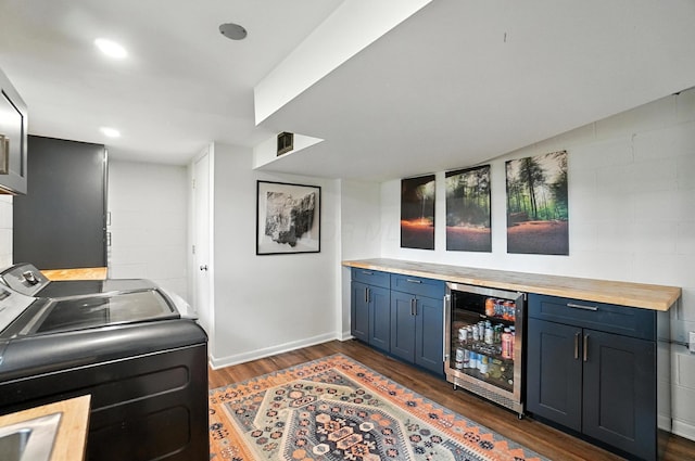 2820 Halstead Rd, Columbus, OH 43221 - washroom with beverage cooler, dark wood finished floors, independent washer and dryer, a bar, and concrete block wall