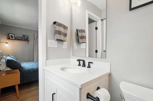 2820 Halstead Rd, Columbus, OH 43221 - ensuite bathroom featuring vanity, wood finished floors, and ornamental molding