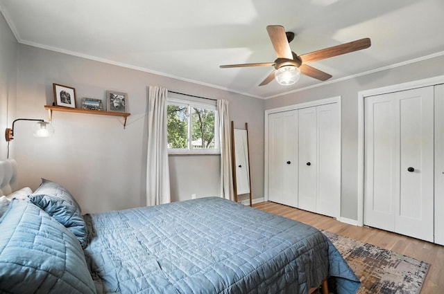2820 Halstead Rd, Columbus, OH 43221 - bedroom with wood finished floors, two closets, ceiling fan, and crown molding
