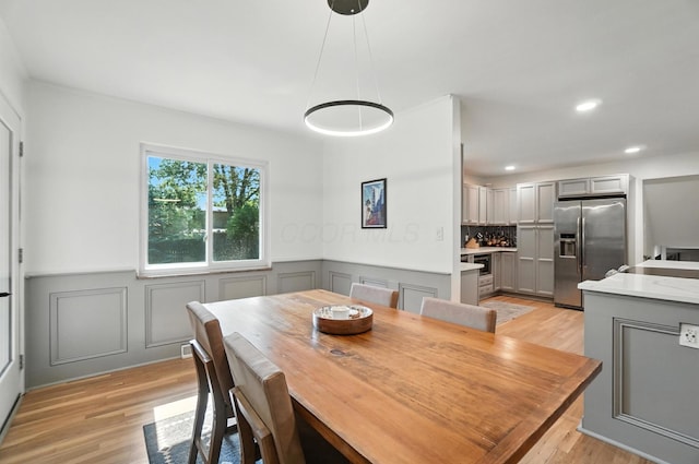 2820 Halstead Rd, Columbus, OH 43221 - dining space featuring light wood finished floors, wainscoting, recessed lighting, and a decorative wall