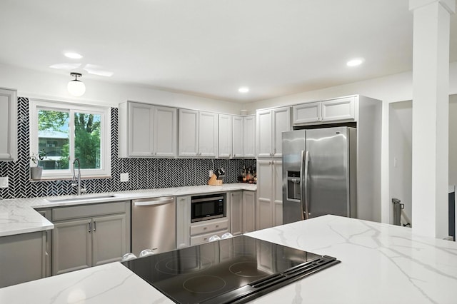 2820 Halstead Rd, Columbus, OH 43221 - kitchen with stainless steel appliances, gray cabinetry, tasteful backsplash, light stone counters, and recessed lighting