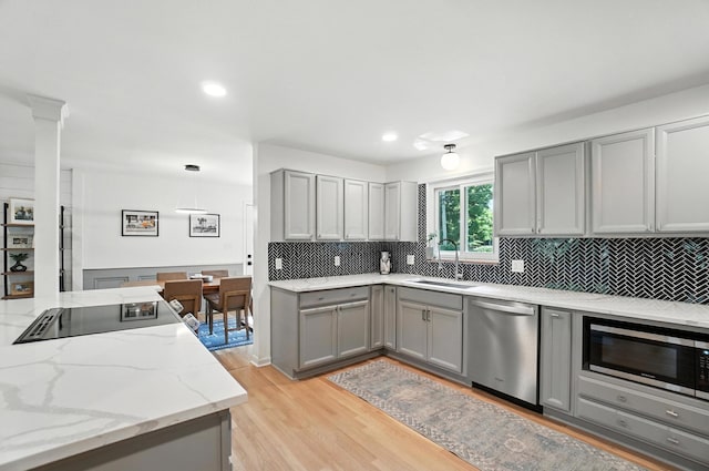 2820 Halstead Rd, Columbus, OH 43221 - kitchen featuring stainless steel appliances, gray cabinetry, backsplash, light wood-style flooring, and recessed lighting