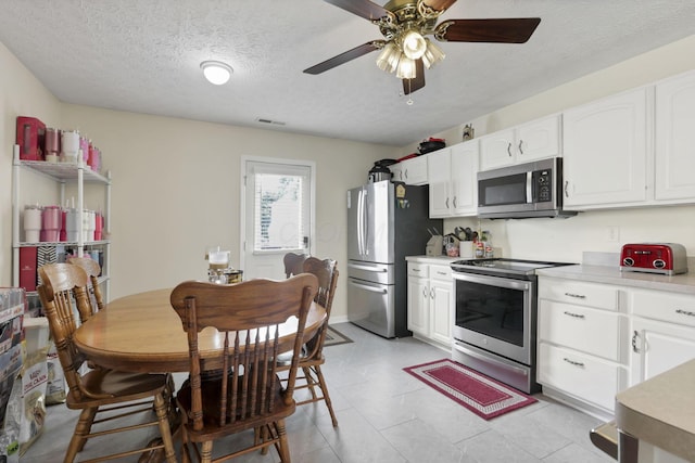 3857 Winding Twig Dr, Canal Winchester, OH 43110 - kitchen featuring appliances with stainless steel finishes, white cabinets, light countertops, and a textured ceiling