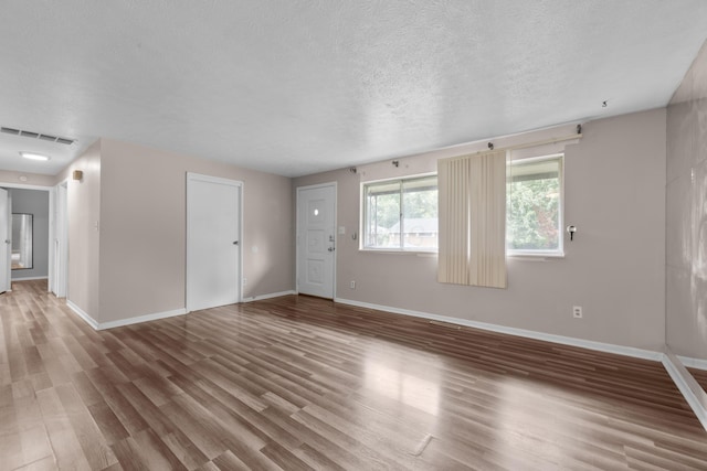 3505 Roswell Dr, Columbus, OH 43227 - unfurnished living room with wood finished floors and a textured ceiling