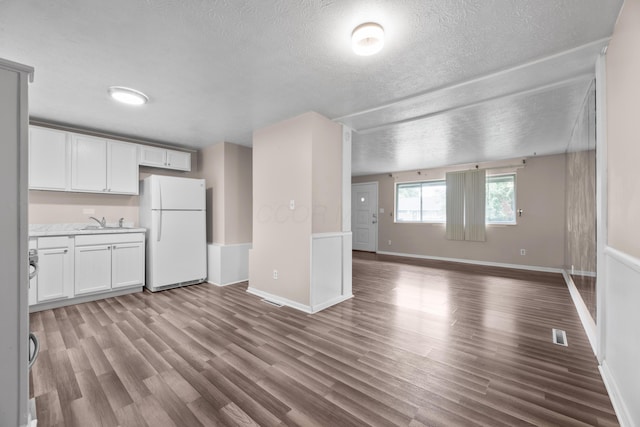 3505 Roswell Dr, Columbus, OH 43227 - unfurnished living room with a textured ceiling and wood finished floors