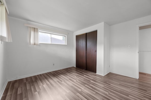 3505 Roswell Dr, Columbus, OH 43227 - unfurnished bedroom with wood finished floors, a closet, and crown molding