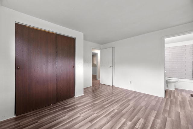3505 Roswell Dr, Columbus, OH 43227 - unfurnished bedroom with a closet, wood finished floors, and ensuite bath