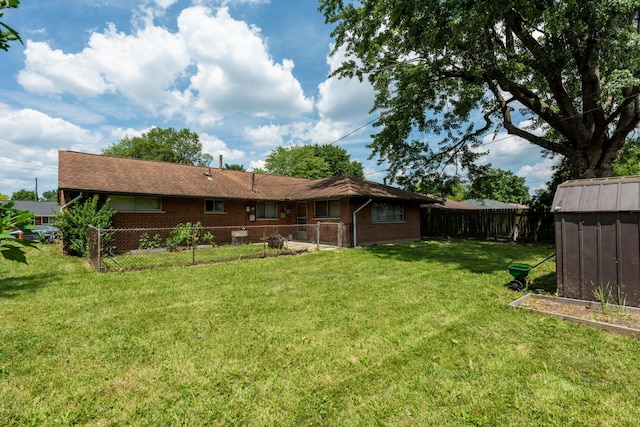 3505 Roswell Dr, Columbus, OH 43227 - rear view of house with a fenced backyard, brick siding, and an outbuilding